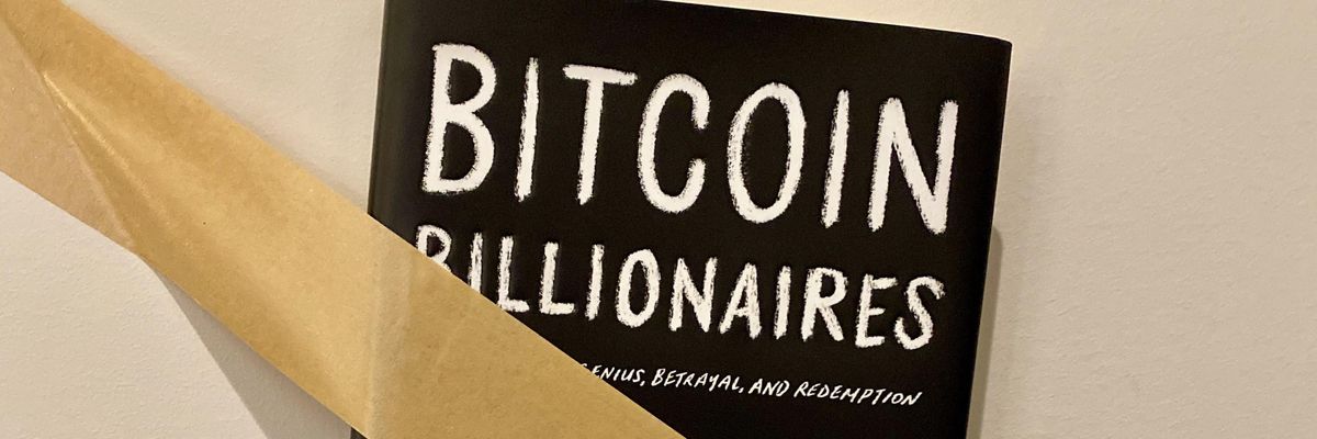 Ben Mezrich's book Bitcoin Billionaires taped to the wall 