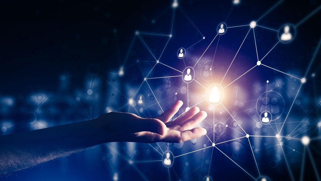 Image of hand inside digital network