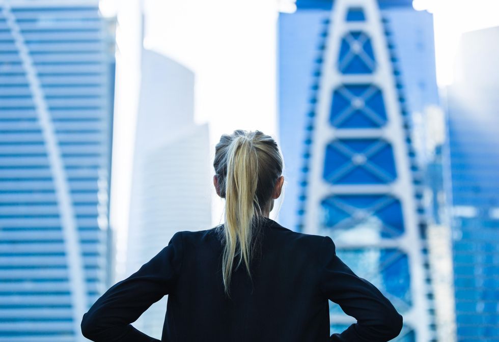 Resolute woman looking out over San Francisco financial district