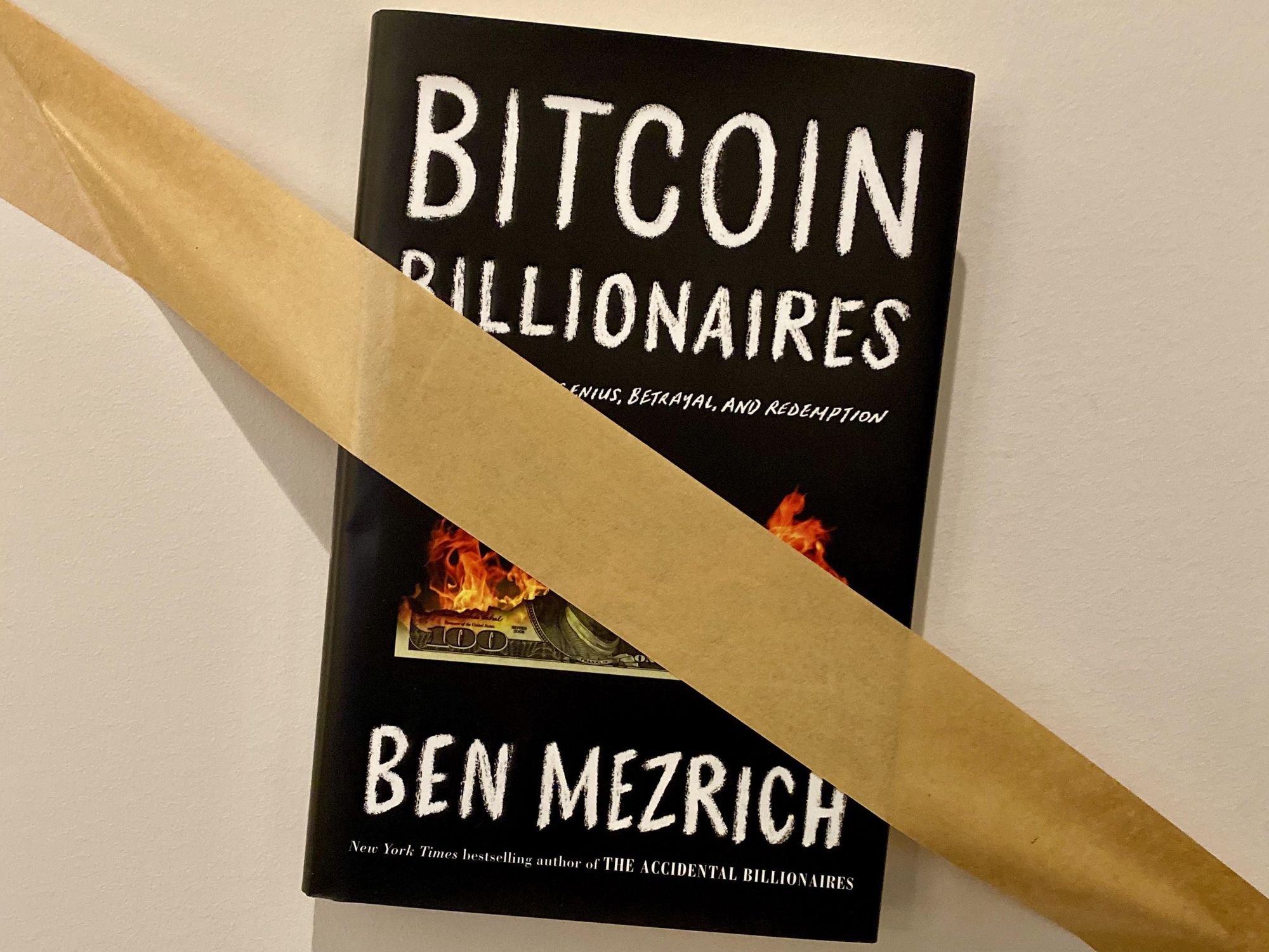 Ben Mezrich's book Bitcoin Billionaires taped to the wall 
