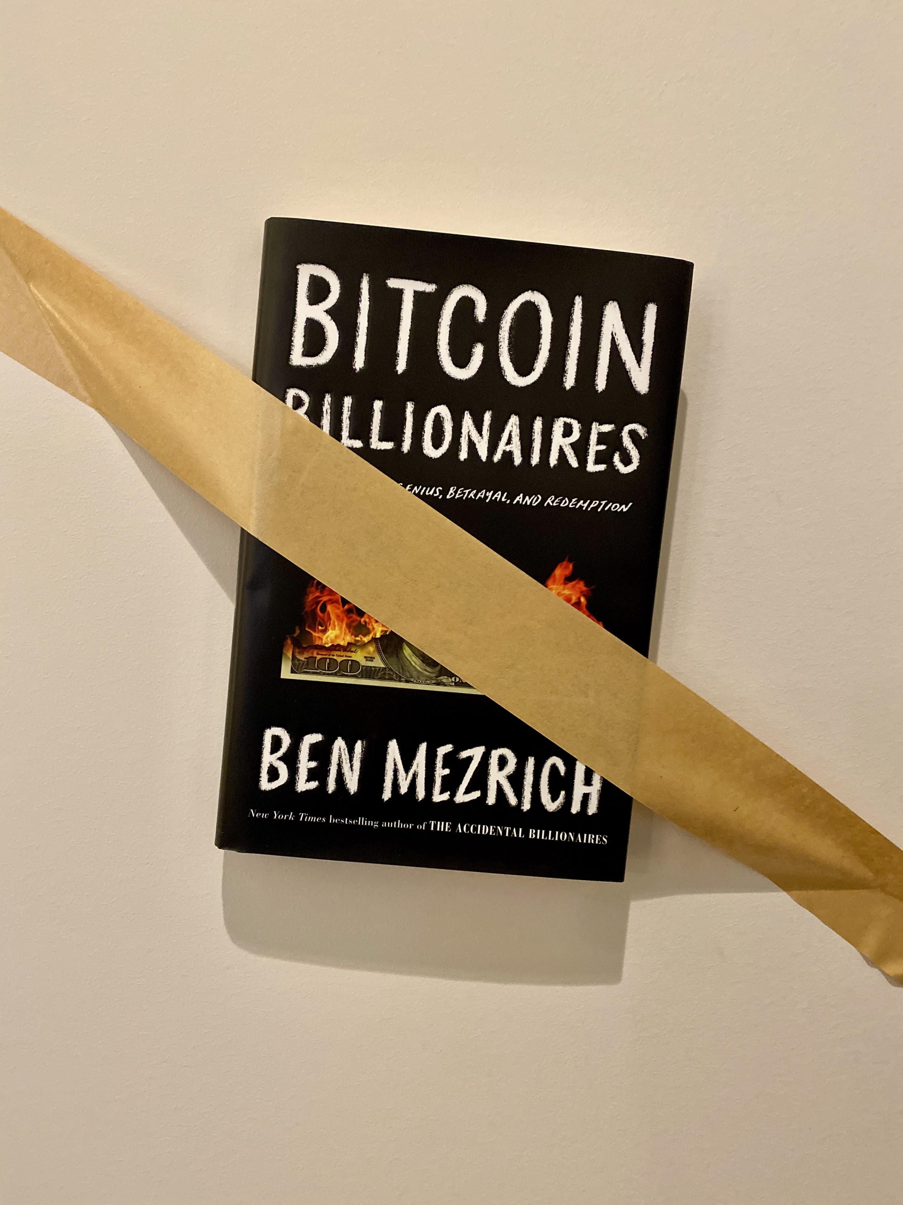 Ben Mezrich's book Bitcoin Billionaires taped to the wall