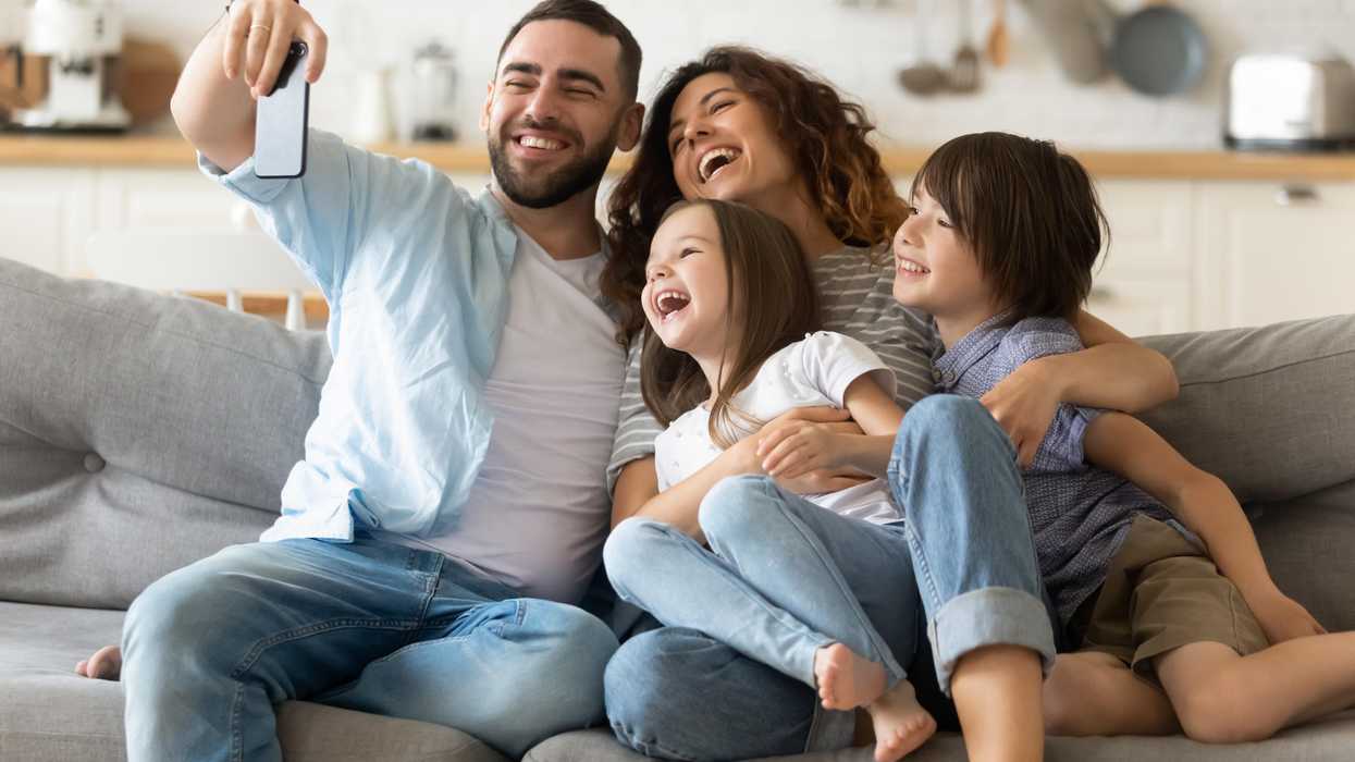 Man investing in cryptocurrency takes selfie with family