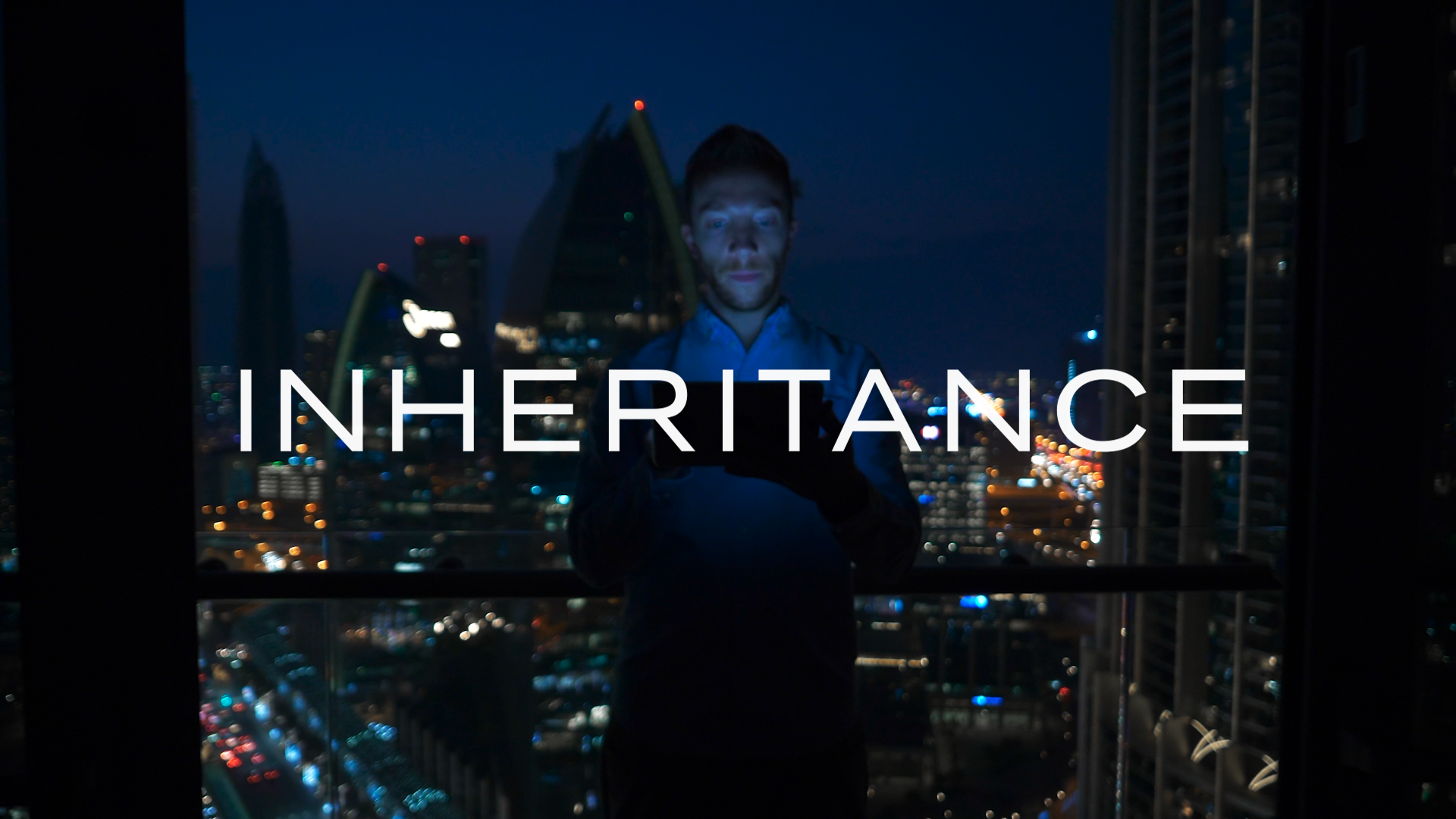 Man standing overlooking city with title Inheritance